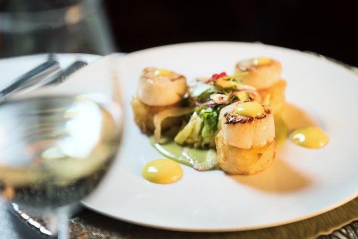 scallops on a plate served on a windstar culinary cruise