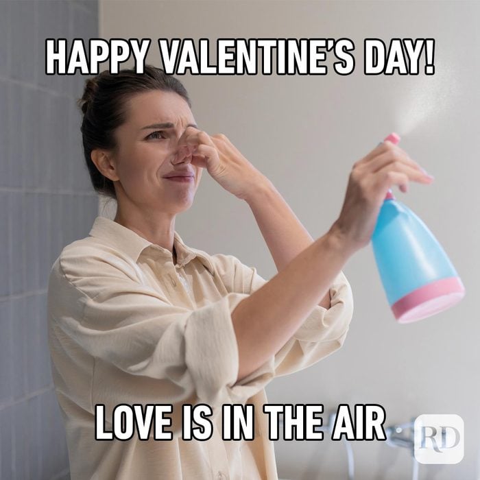Funny Valentines Day Memes Everyone Can Relate To woman holding her nose and spraying perfume in the air meme with copy "Happy Valentine's Day! Love is in the air"