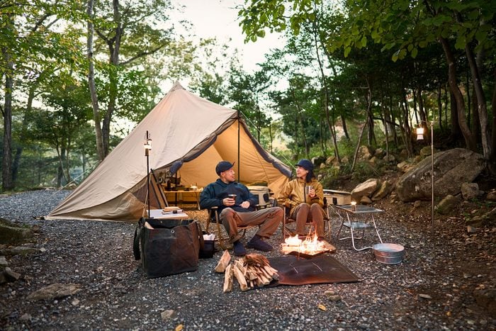 Couple Enjoys Camping At A Campground In The Woods