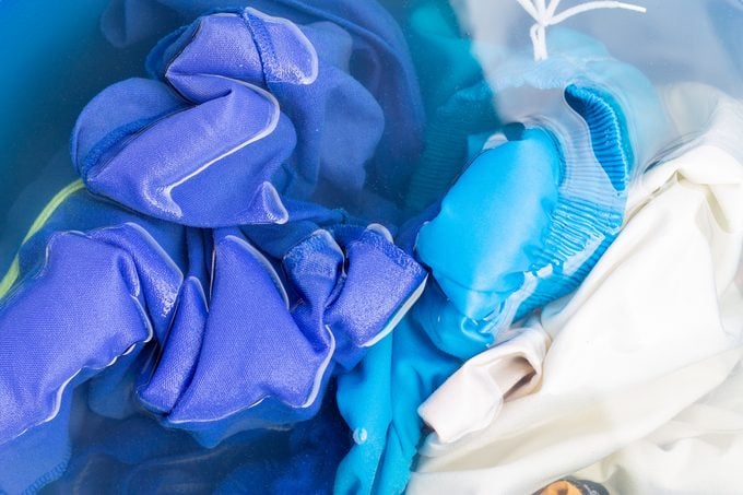 Soak colored clothes before washing them with water.