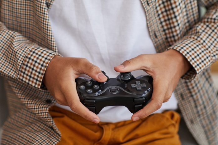 African-American Boy Holding Gamepad Close Up