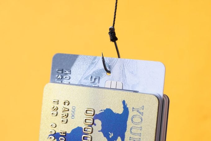 fish hook in credit cards on a yellow background