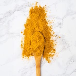 turmeric on spoon on marble counter