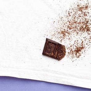 chocolate stain on white shirt on a purple background