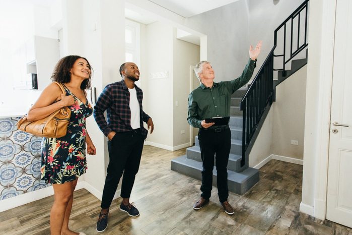 Real estate agent showing a house to black couple