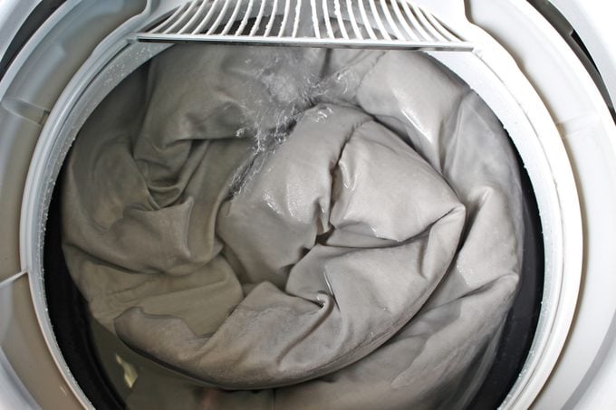 Roll up the duvet and put it in the washing machine.