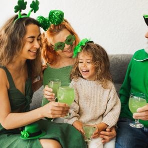 Happy family celebrating St. Patrick's Day.