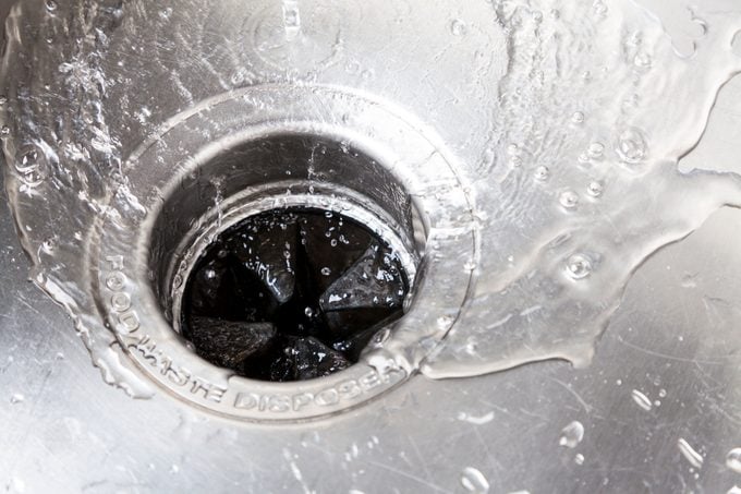 Kitchen sink with water going down disposal
