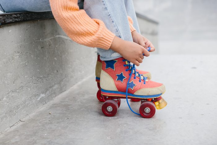 Close-up Of Legs Wearing Roller Skating Shoe, Outdoors