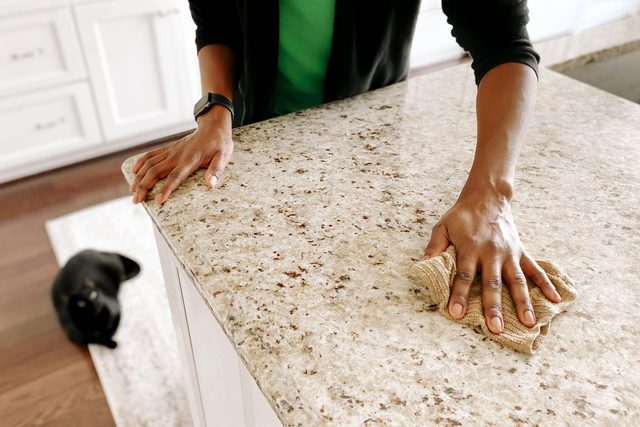woman cleaning kitchen counter