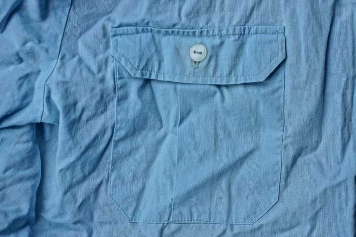blue fabric texture from crumpled shirt with pocket