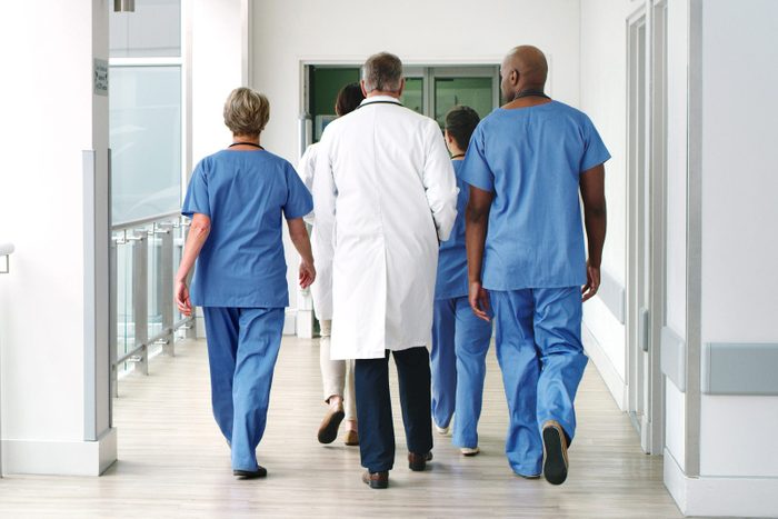 Shot of a diverse group of uunrecognizable medical practitioners walking in the hallway of the hospital