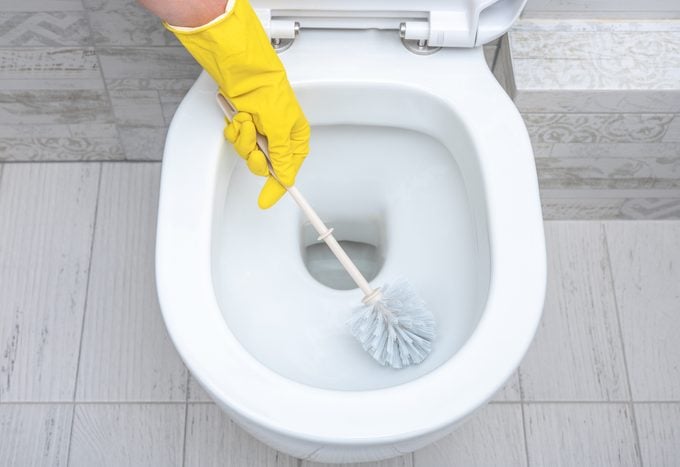 cleaning wc. Housekeeper, cleaning man at toilet. Brush up Toilet for cleanliness and hygiene. cleaning toilet bowl. Cleaning service concept