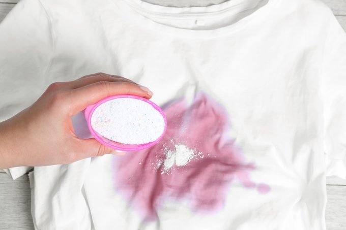 pretreating a large red stain on a white shirt with powder detergent