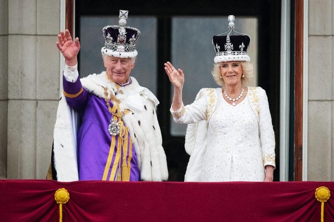 King Charles III And Queen Camilla on the balcony waving