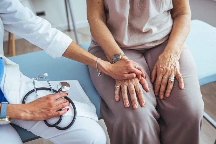 Cropped shot of a female doctor hold her senior patient's hand.