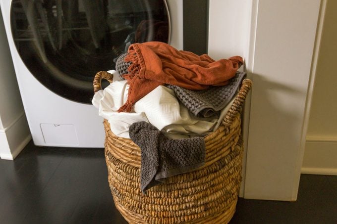 Full Laundry Basket in Front of Washing Machine and Dryer, Domestic Life Household Chores