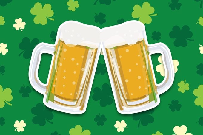 two beers cheers on a green shamrock pattern background