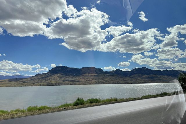 A view of river and mountains from a car