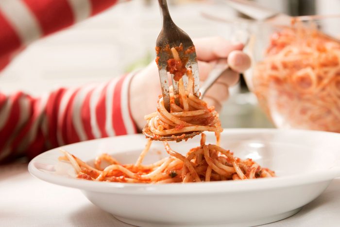 Child eating spaghetti,