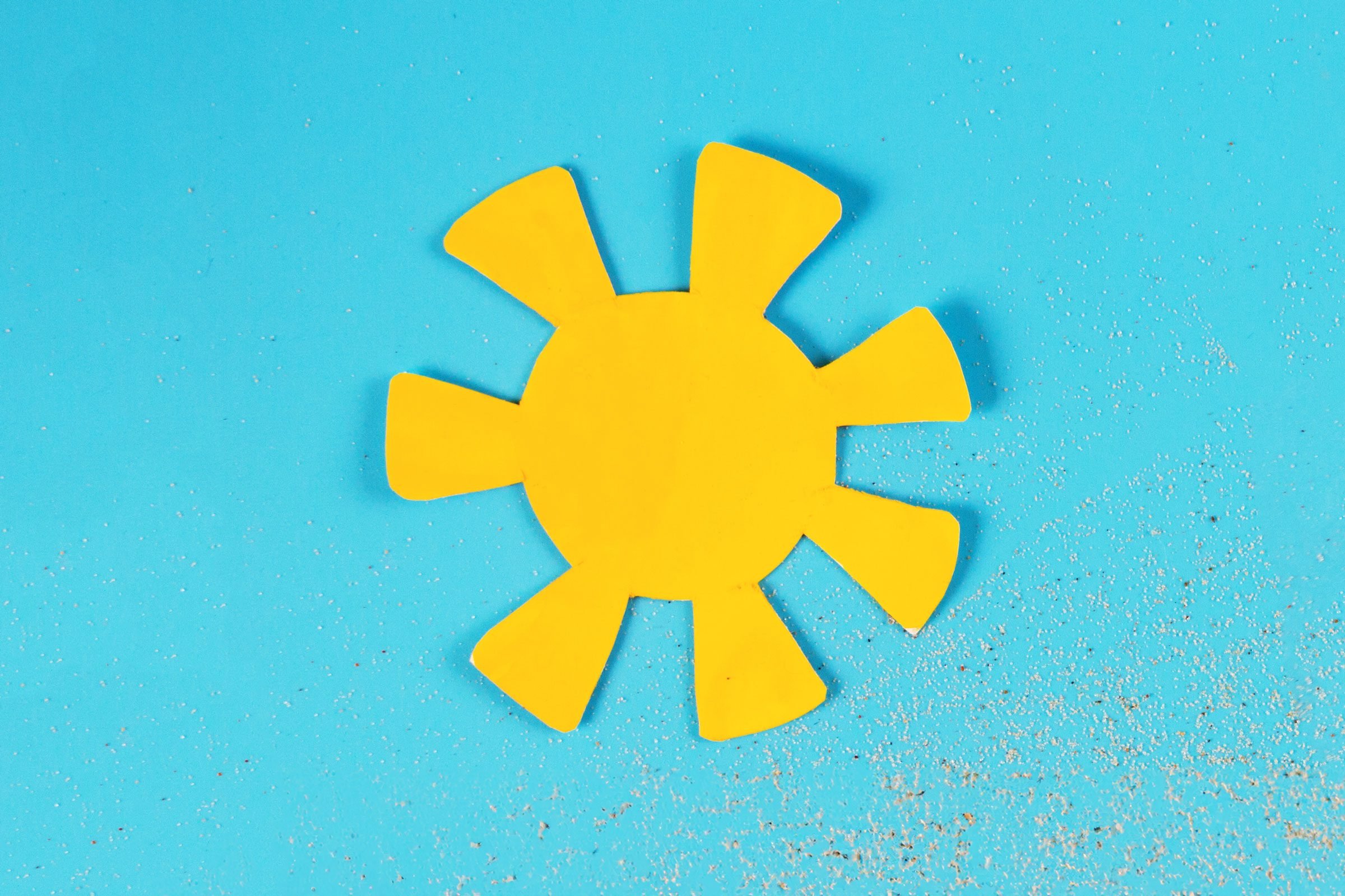 paper sun on a blue background