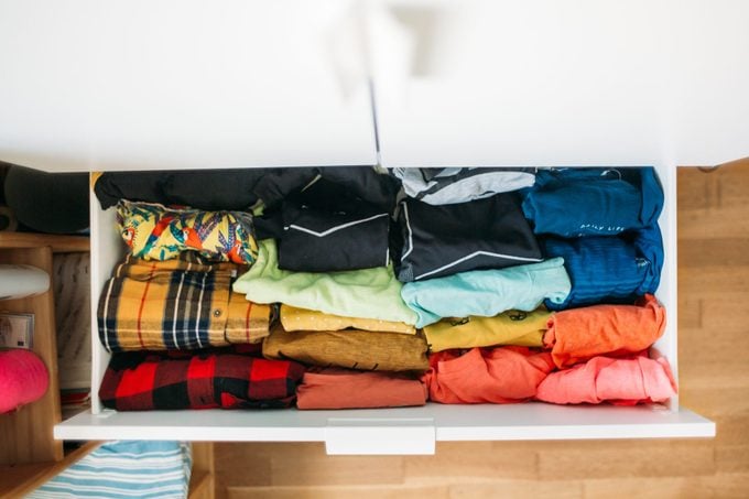 colorful shirts in a white drawer