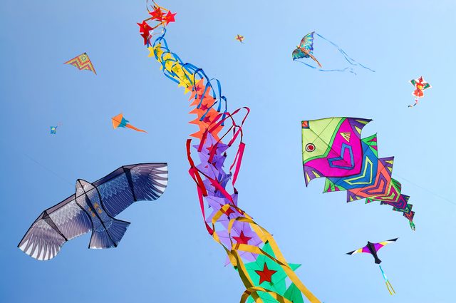Kites flying in clear blue sky, India - stock photo