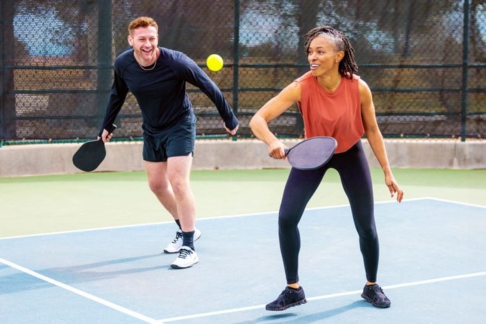 couple on a date playing pickle ball