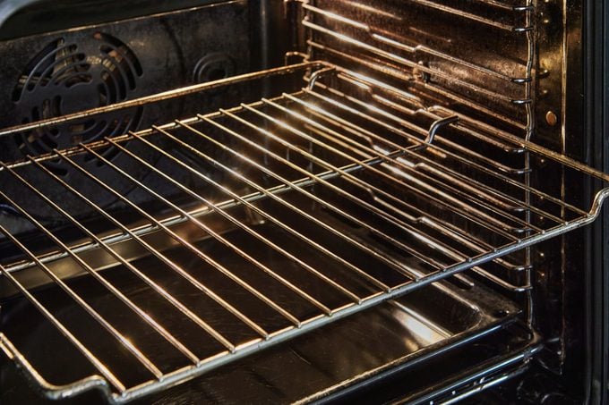 Chrome Elegance: Sleek Grill and Drip Tray Define the Allure of the Oven's Inner Chamber