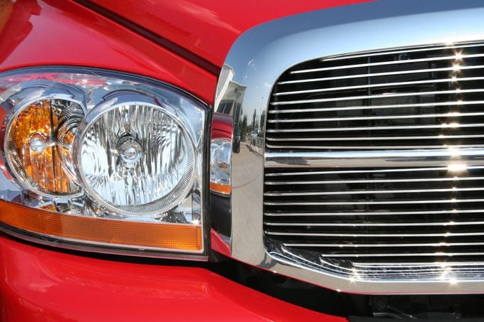 Headlights and grill of a red sports car.