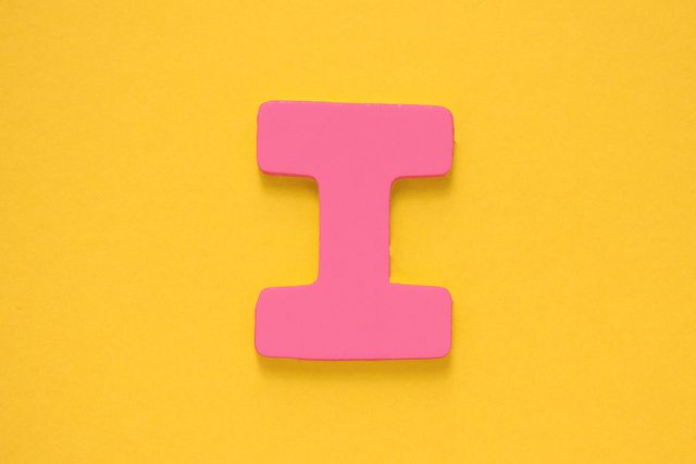 pink letter "I" on a yellow background