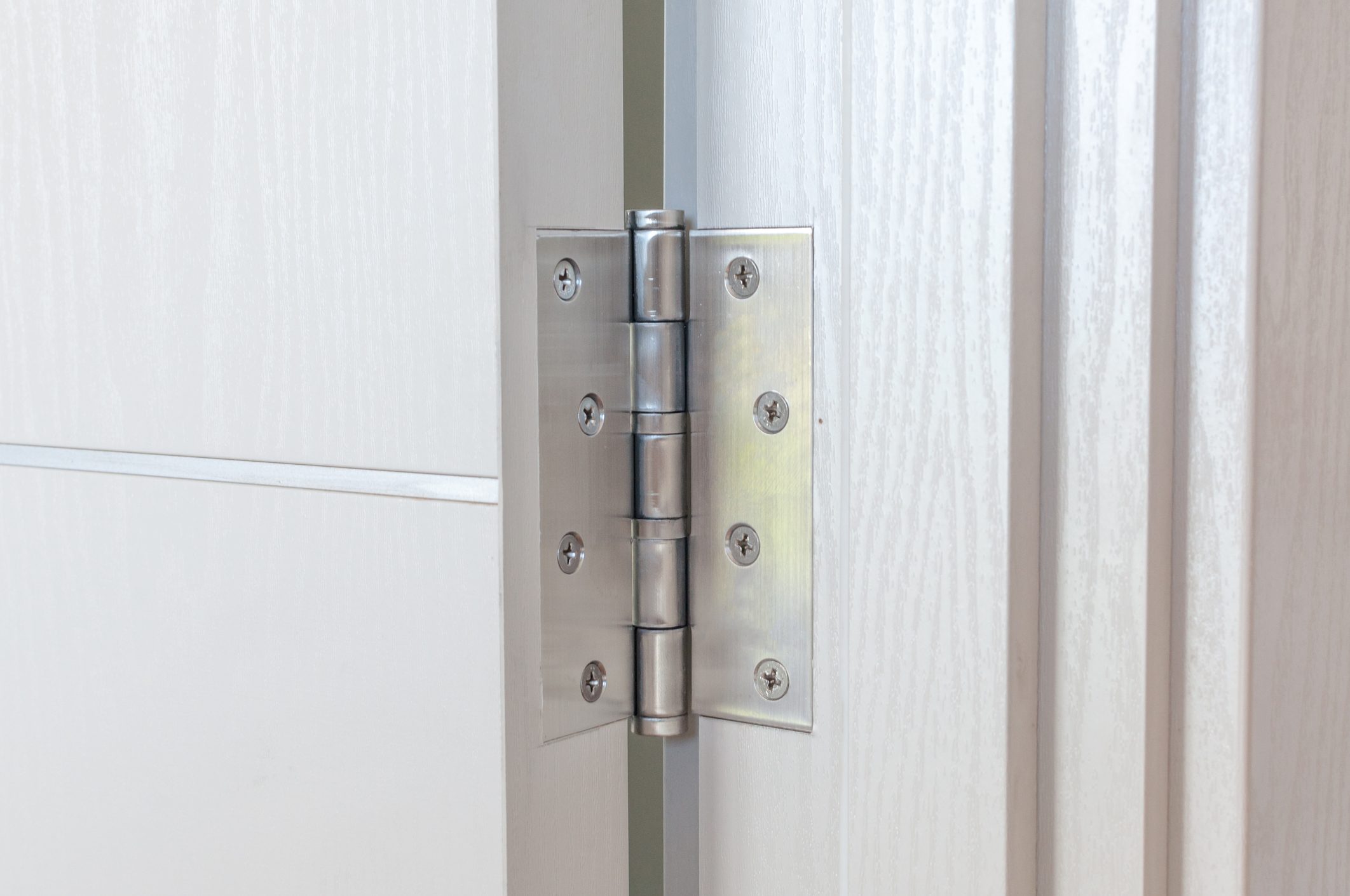 Aluminum door hinges on white door