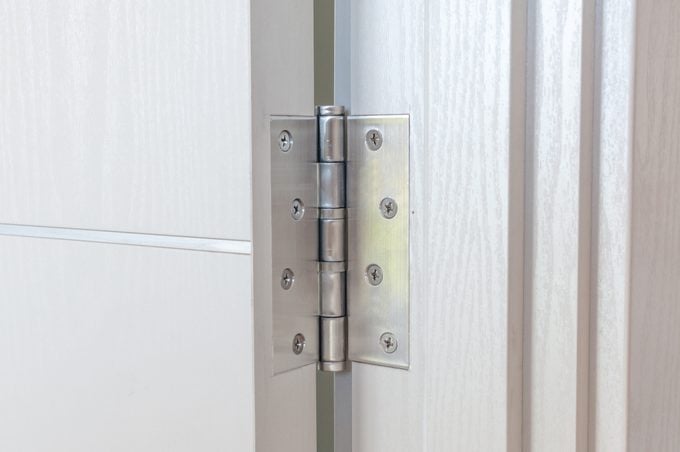 Aluminum door hinges on white door
