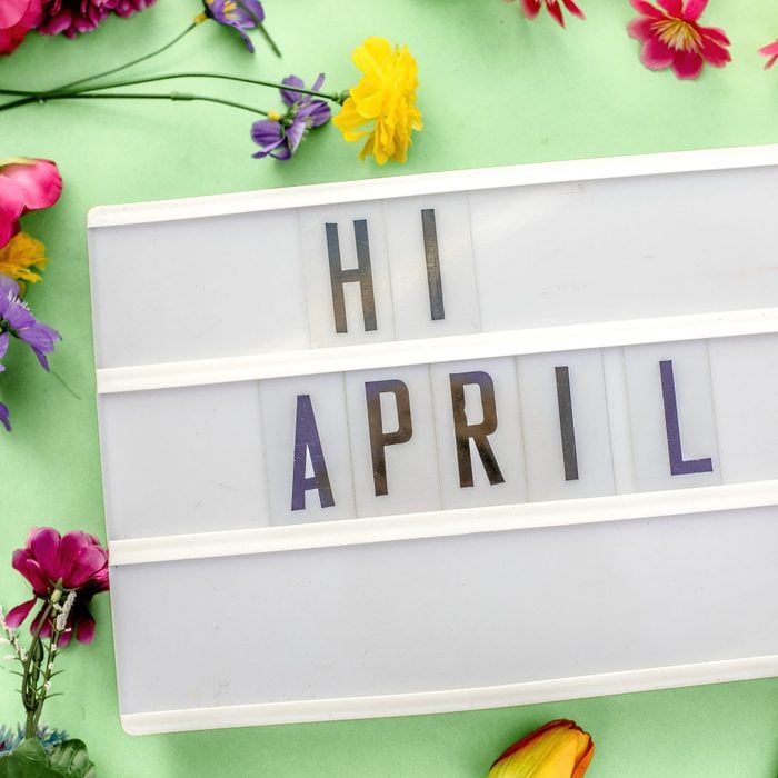 april message in lightbox. Floral and gren bacground
