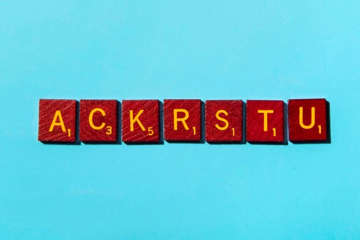 "ACKRSTU" in scrabble letters on a blue background