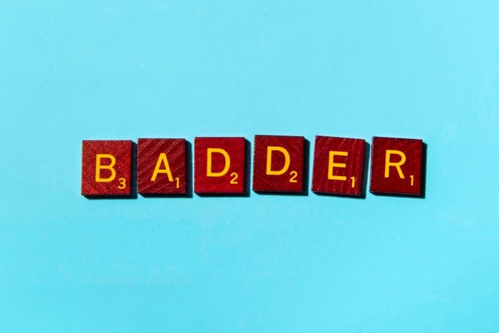 "BADDER" in scrabble letters on a blue background
