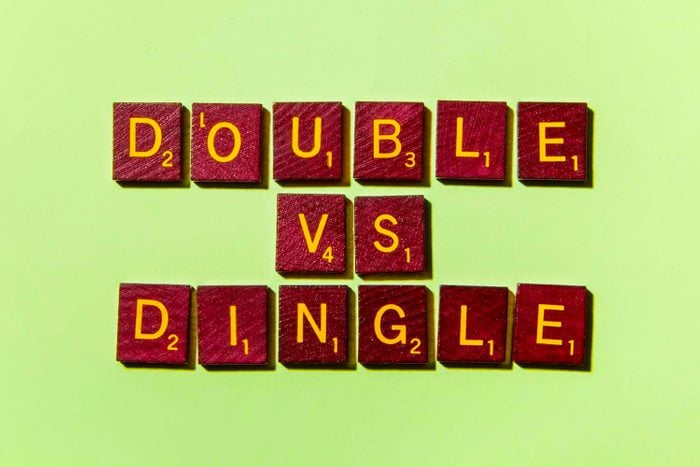 "DOUBLE VS DINGLE" in scrabble letters on a green background