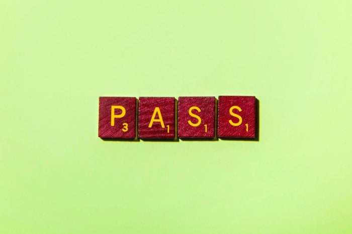 "PASS" in scrabble letters on a green background