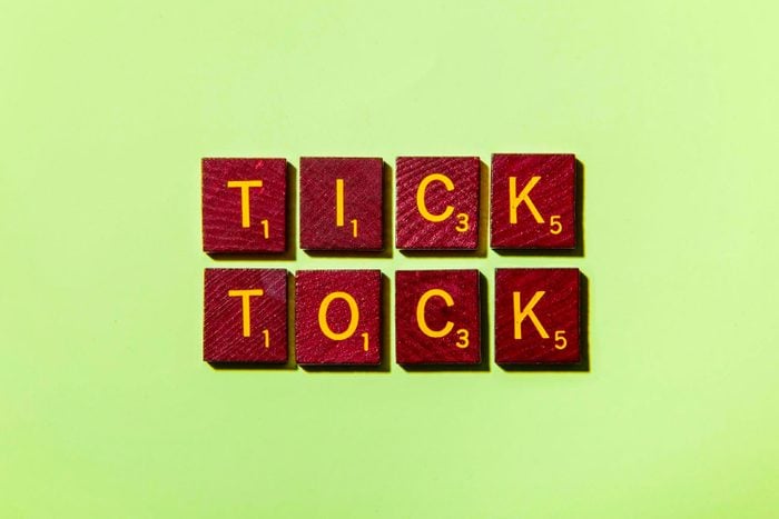 "TICK TOCK" in scrabble letters on a green background