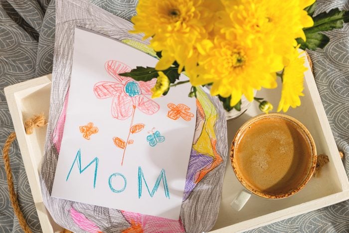 A gift from a child for mothers day - a card from a picture and coffee in bed in the morning
