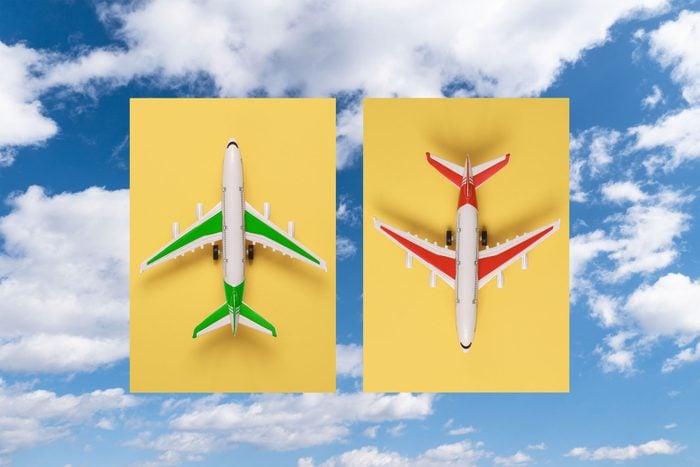 collage of two airplanes over a blue sunny sky with clouds. the plane on the left is green and pointing up. the plane on the right is red and pointing down