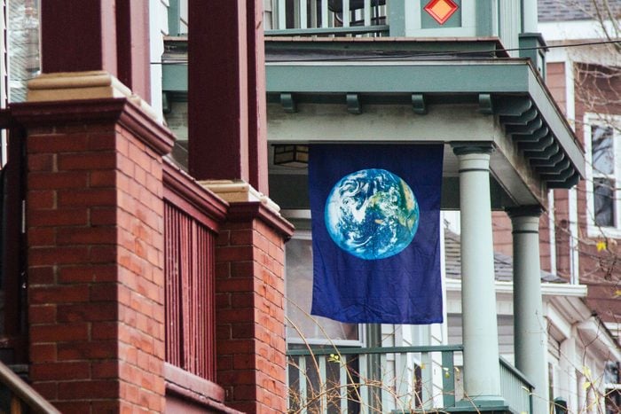 An Earth Flag hangs from the stoop of a home on Sherman Avenue in the Parkside Neighborhood in Portland, ME
