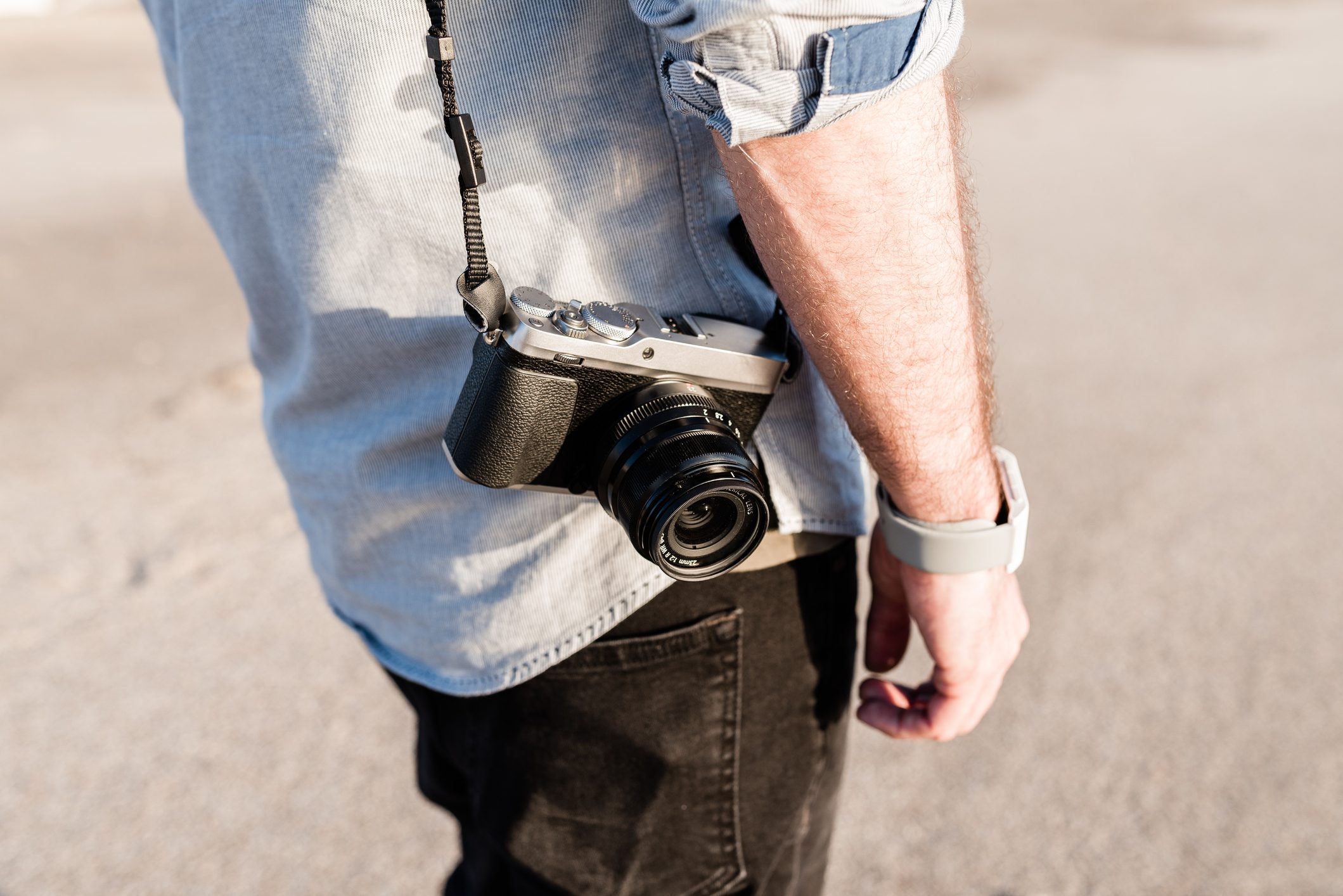 man holding a mirrorless digital camera
